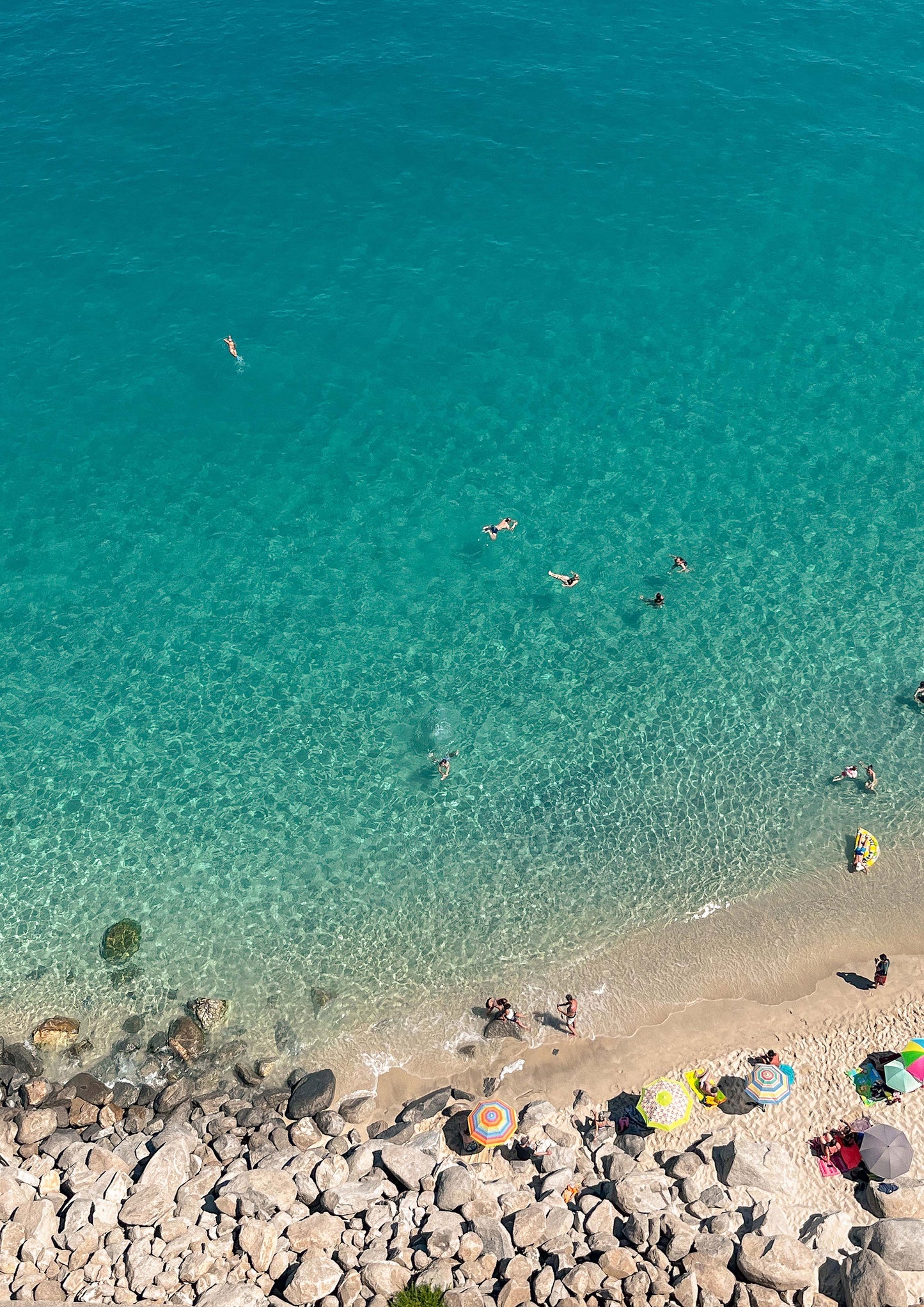 Fine art photograph titled “Acque di Cristallo,” showcasing crystal-clear Mediterranean waters along the Italian coast, with shimmering sunlight and serene blue hues. This coastal image evokes purity, calm, and summer escape—ideal for beach-inspired, minimalist, or refreshing interior design.