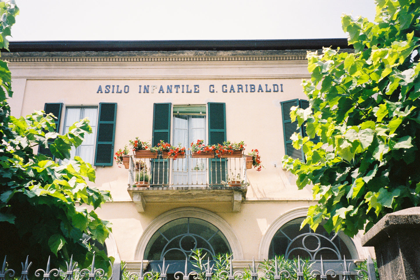 Fine art photograph of an old Italian “Asilo Infantile” (children’s school), featuring faded pastel walls, vintage signage, and nostalgic architectural charm. This image captures the quiet beauty of small-town Italy—perfect for vintage-inspired, educational, or sentimental interior spaces.