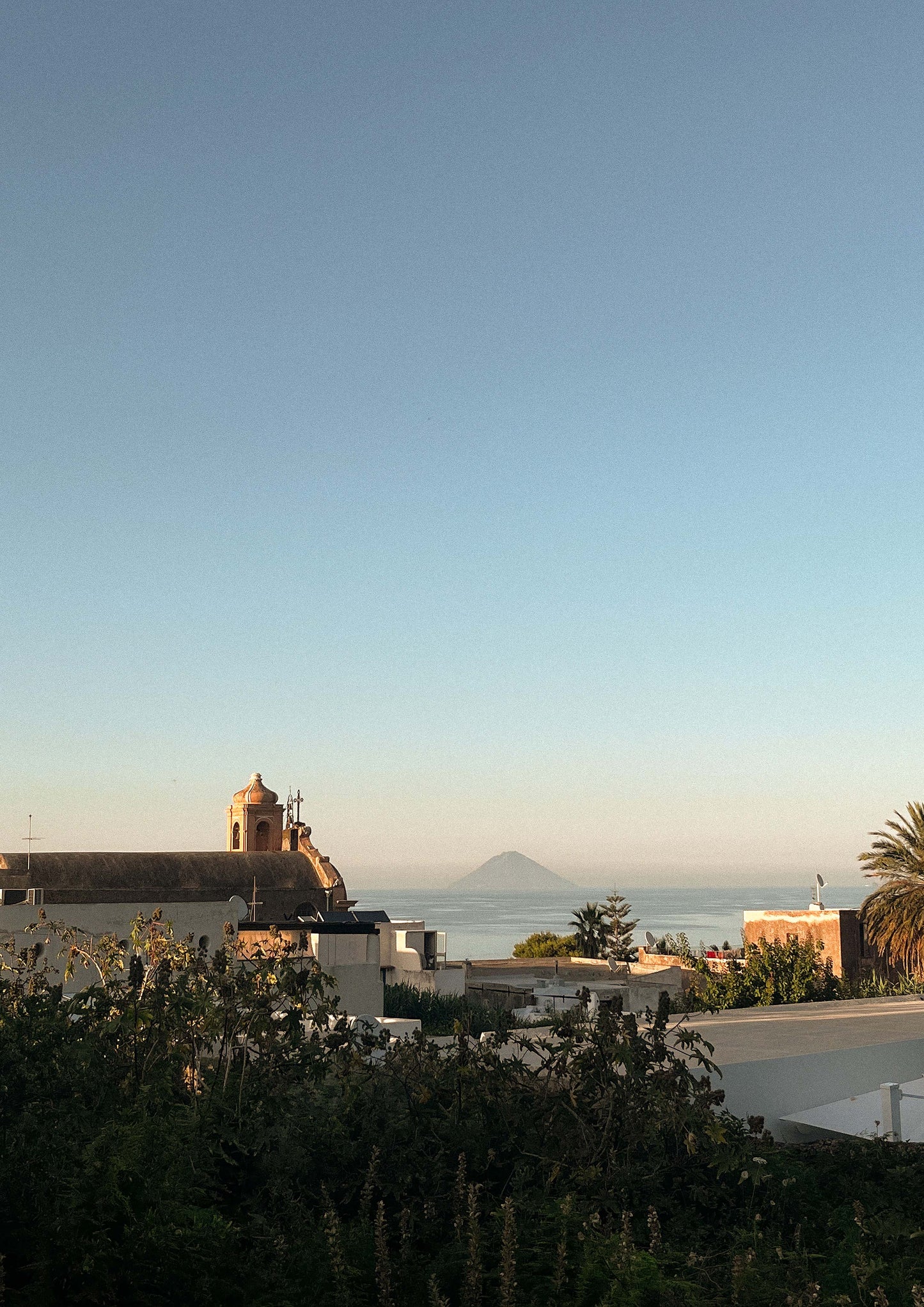 Fine art print of Vulcano di Stromboli at sunset, featuring a glowing volcanic silhouette against a dusky Mediterranean sky. Captured in southern Italy, this minimalist photograph evokes the timeless beauty and drama of the Aeolian Islands. Perfect for coastal, bohemian, or European-inspired interior design.