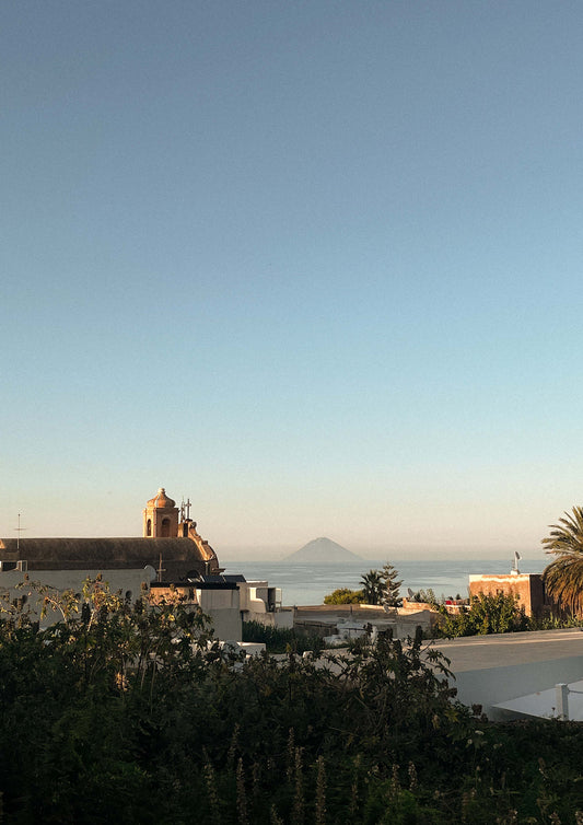Fine art print of Vulcano di Stromboli at sunset, featuring a glowing volcanic silhouette against a dusky Mediterranean sky. Captured in southern Italy, this minimalist photograph evokes the timeless beauty and drama of the Aeolian Islands. Perfect for coastal, bohemian, or European-inspired interior design.