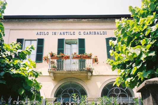 Fine art photograph of an old Italian “Asilo Infantile” (children’s school), featuring faded pastel walls, vintage signage, and nostalgic architectural charm. This image captures the quiet beauty of small-town Italy—perfect for vintage-inspired, educational, or sentimental interior spaces.